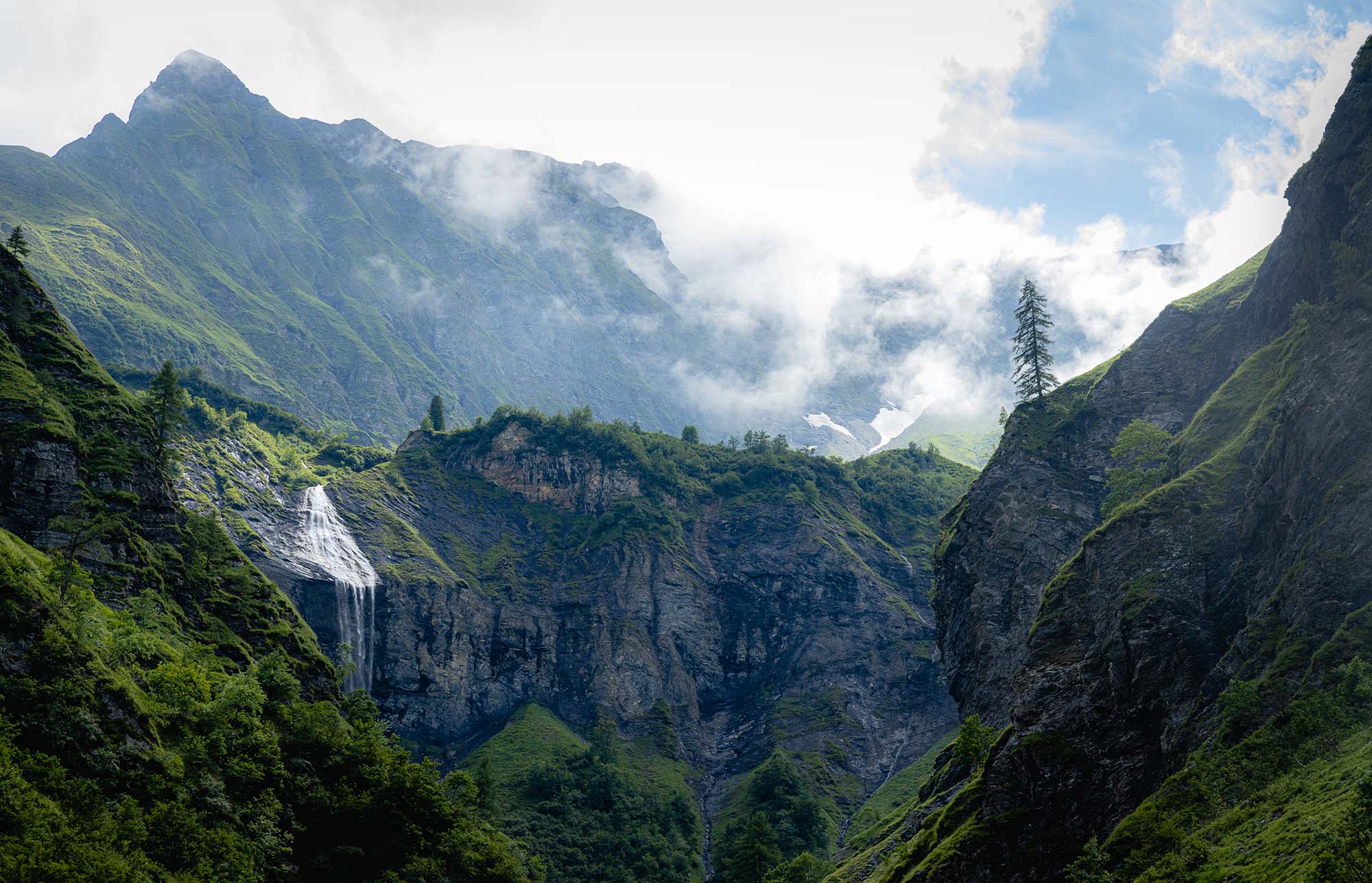 picture of landscape with mountains, trees and a waterfall in weisstannen switzerland
