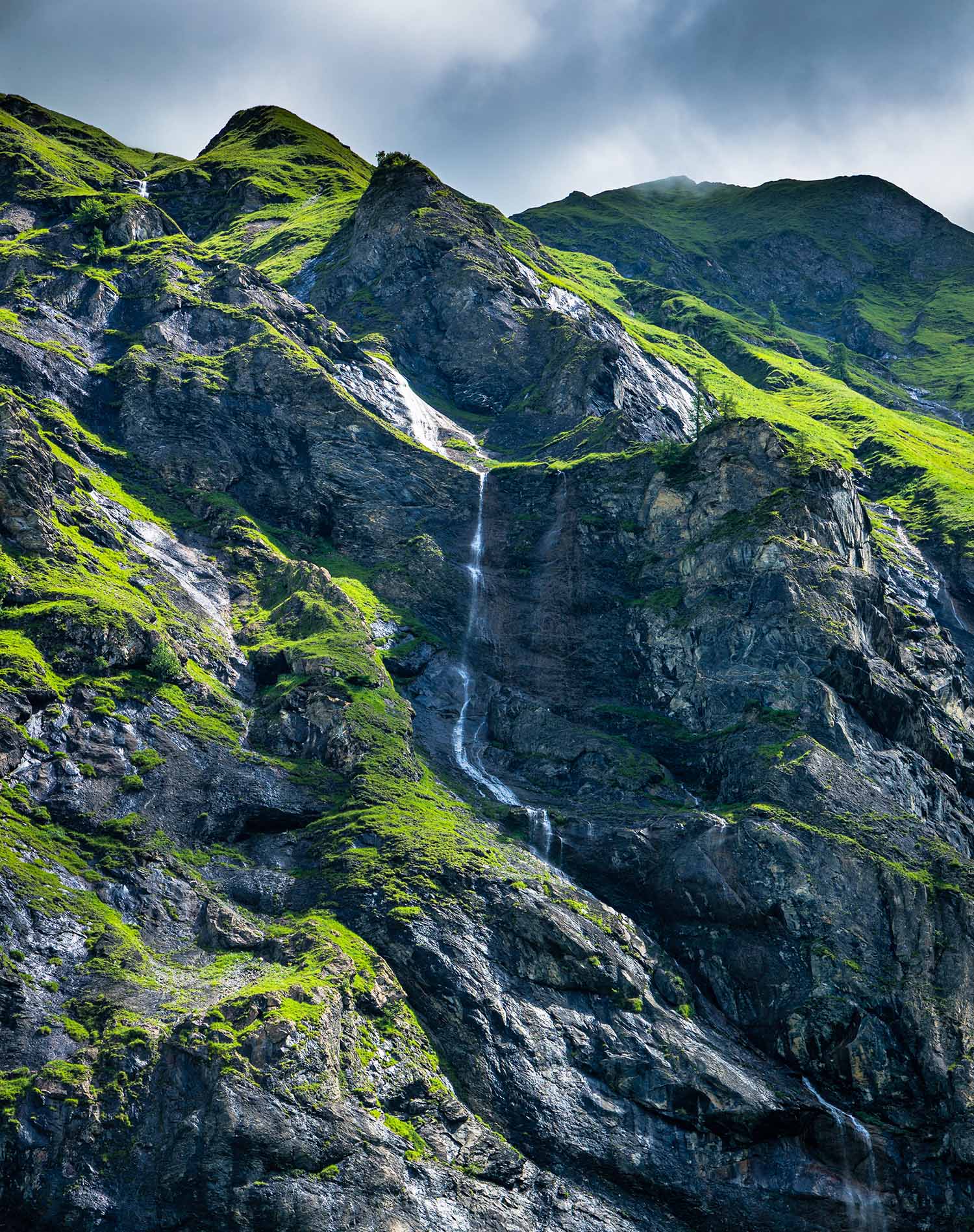 picture of a mountain with a waterfall in weisstannen switzerland